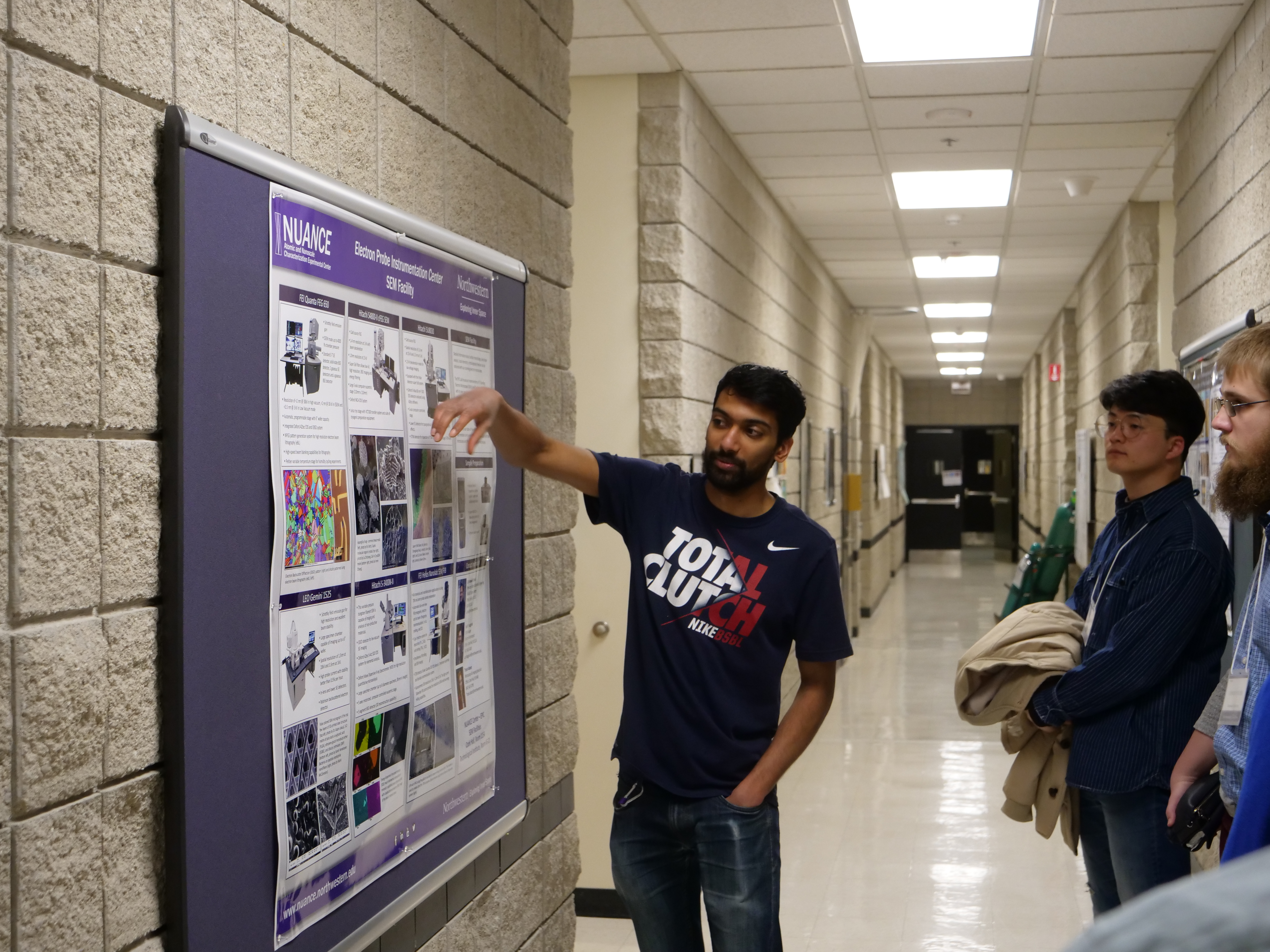 Akshay Murthy discusses a research poster during the Mechanical Engineering tour.