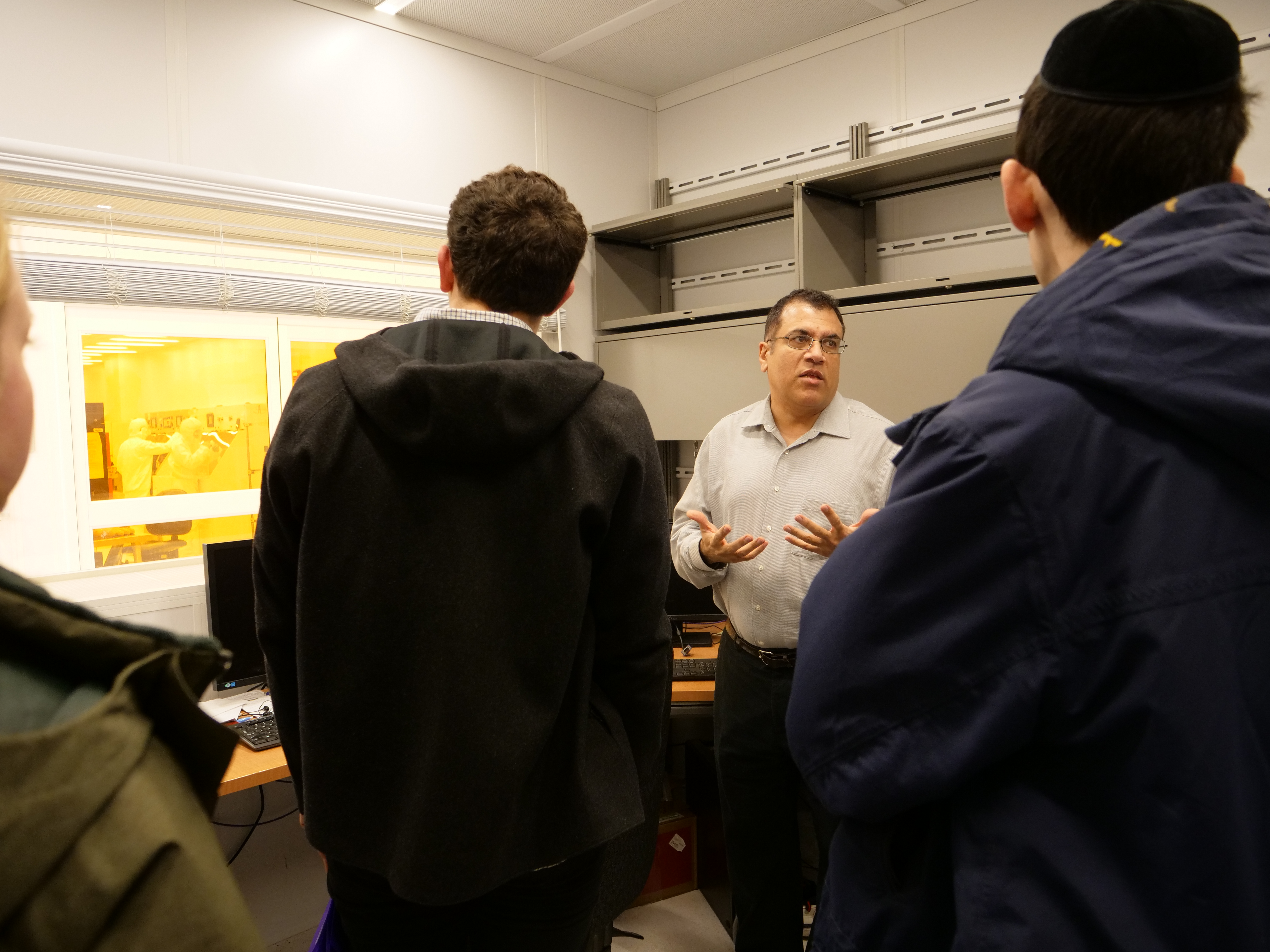 NUFAB facility manager Nasir Basit discusses the facility's capabilities in his office with prospective Applied Physics students.