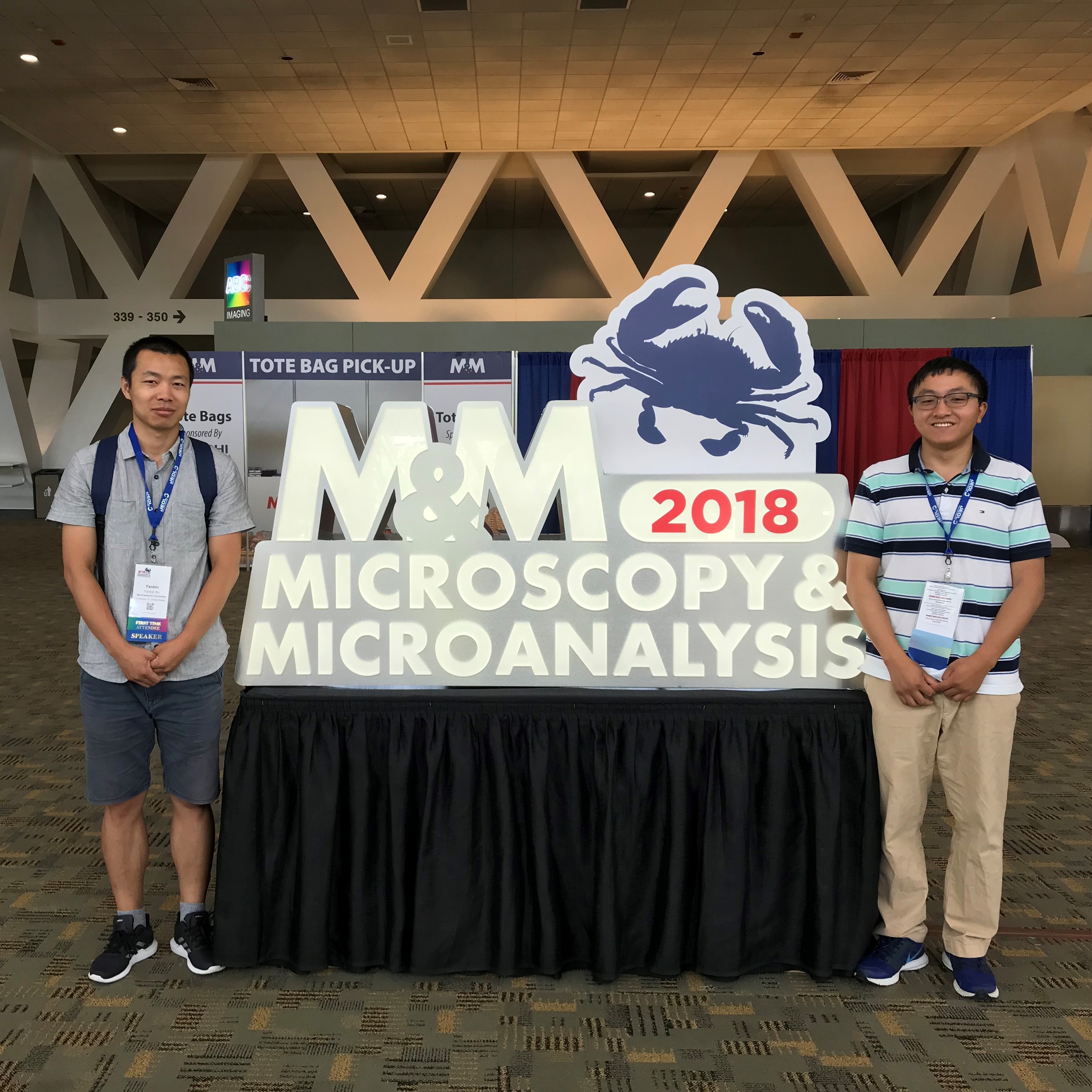 Technical staff members Yaobin Xu (left) and Xiaobing Hu (right) posing for a picture