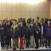 Students pose for a group photo in the lobby of Cook Hall.