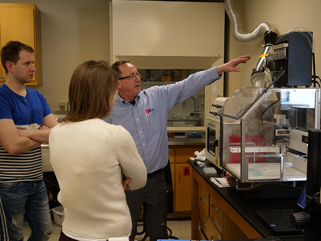 presenter showing attendees some of the new equipment capabilities