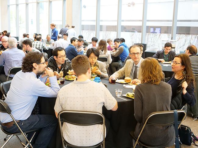 participants in breakout groups over lunch