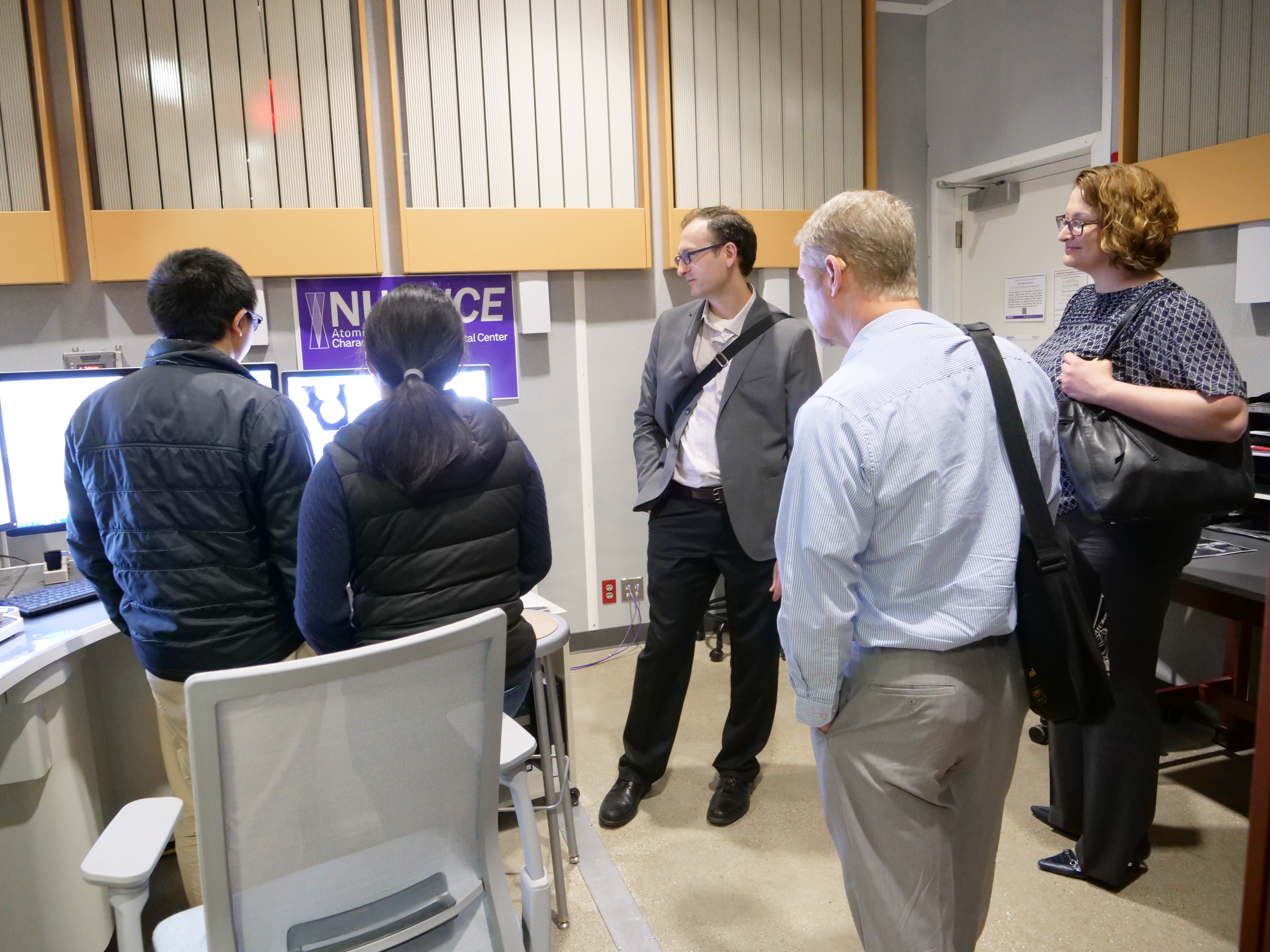 guests from Regis observe Dr. Hu