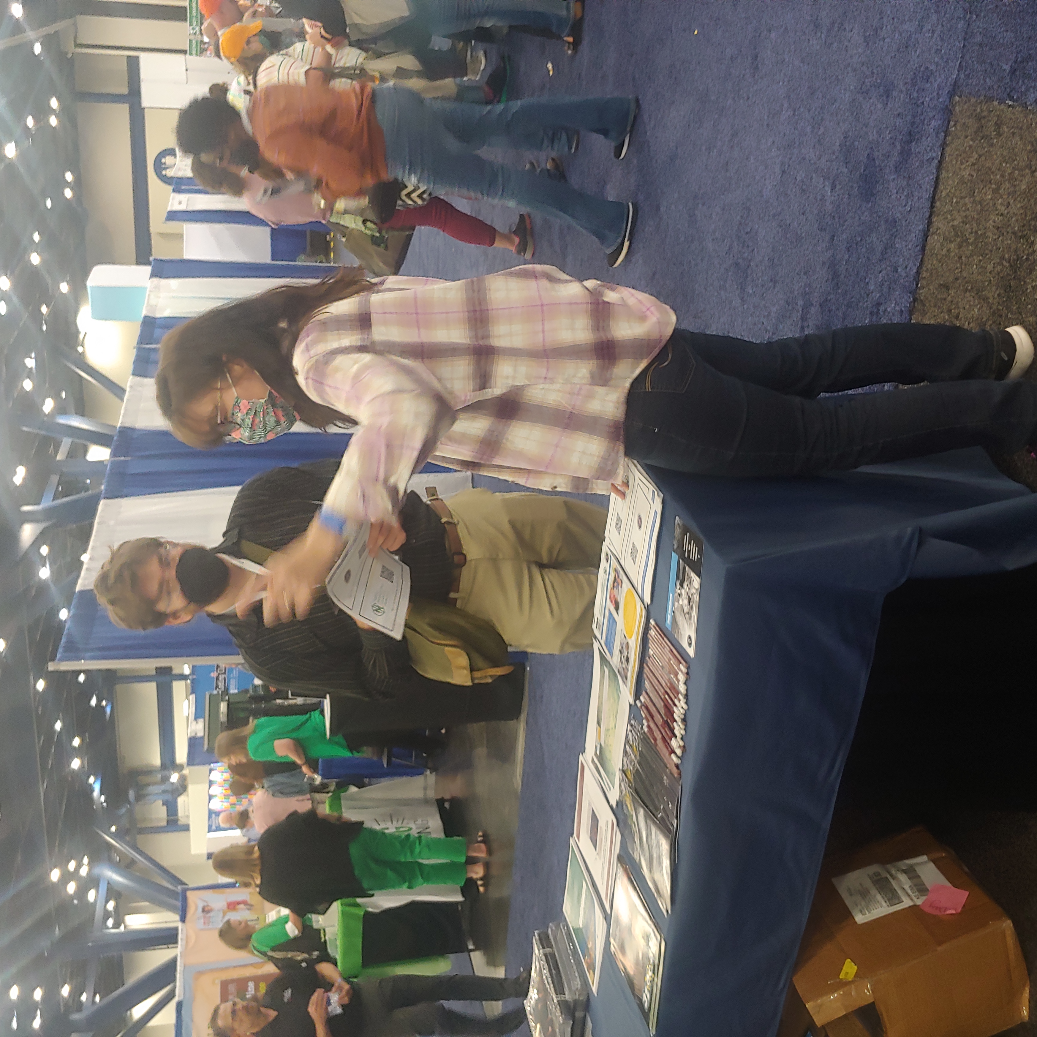 Quinn Spadole, Georgia Tech, engages with a teacher relaying the many educational resources available through the NNCI.