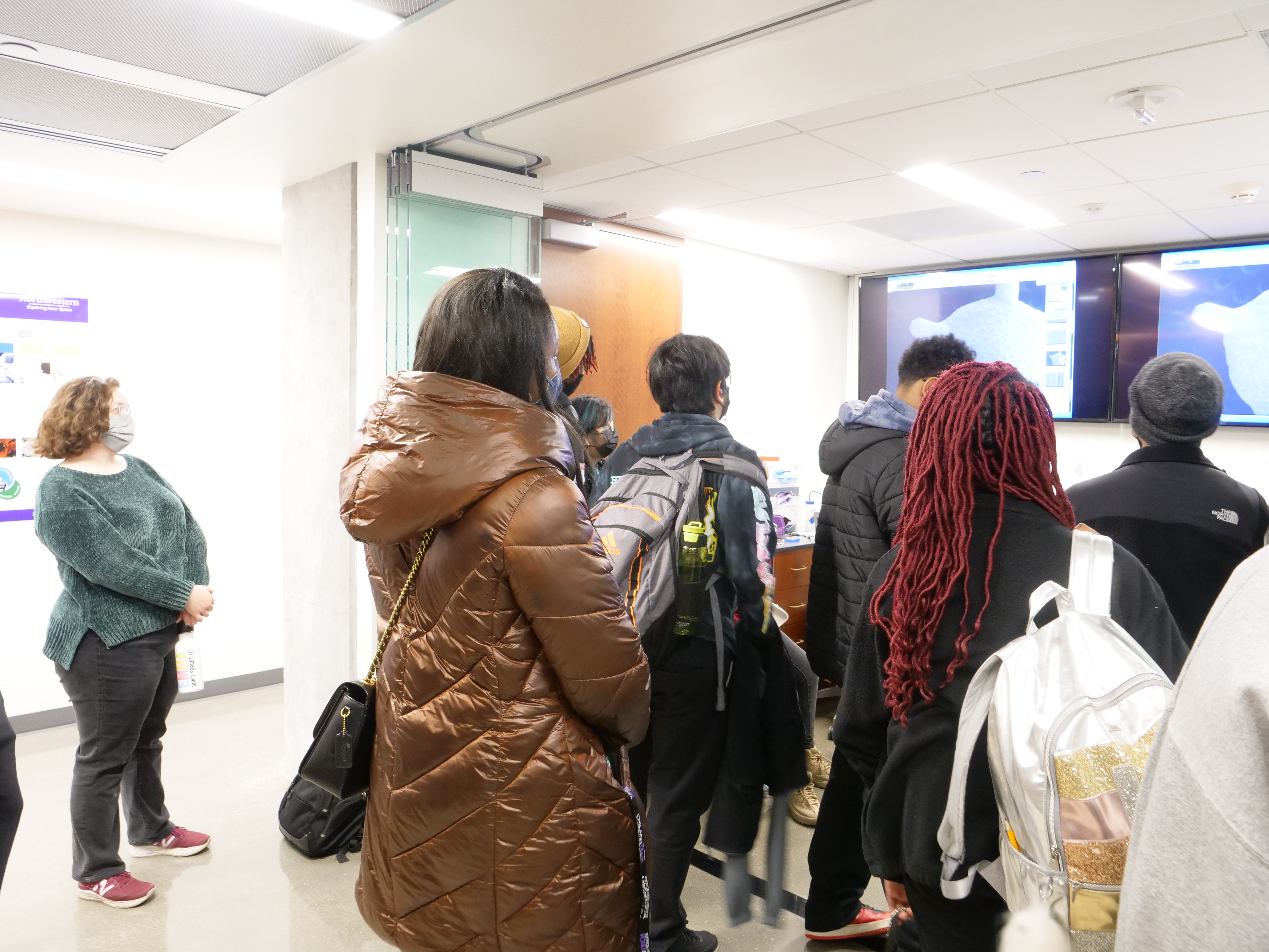 Students looking at a sample